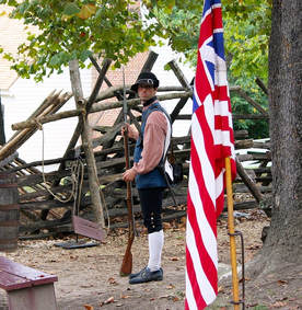 Colonial soldier and the Grand Union flag, the first flag of the United States. (DeMers, 2012)